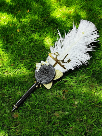 Black Ribbon Flower and Golden petals With Ostrich Fur Pen on grass Nikkahday